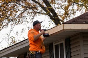 A gutter installation by Lindus Construction on a home in the fall.