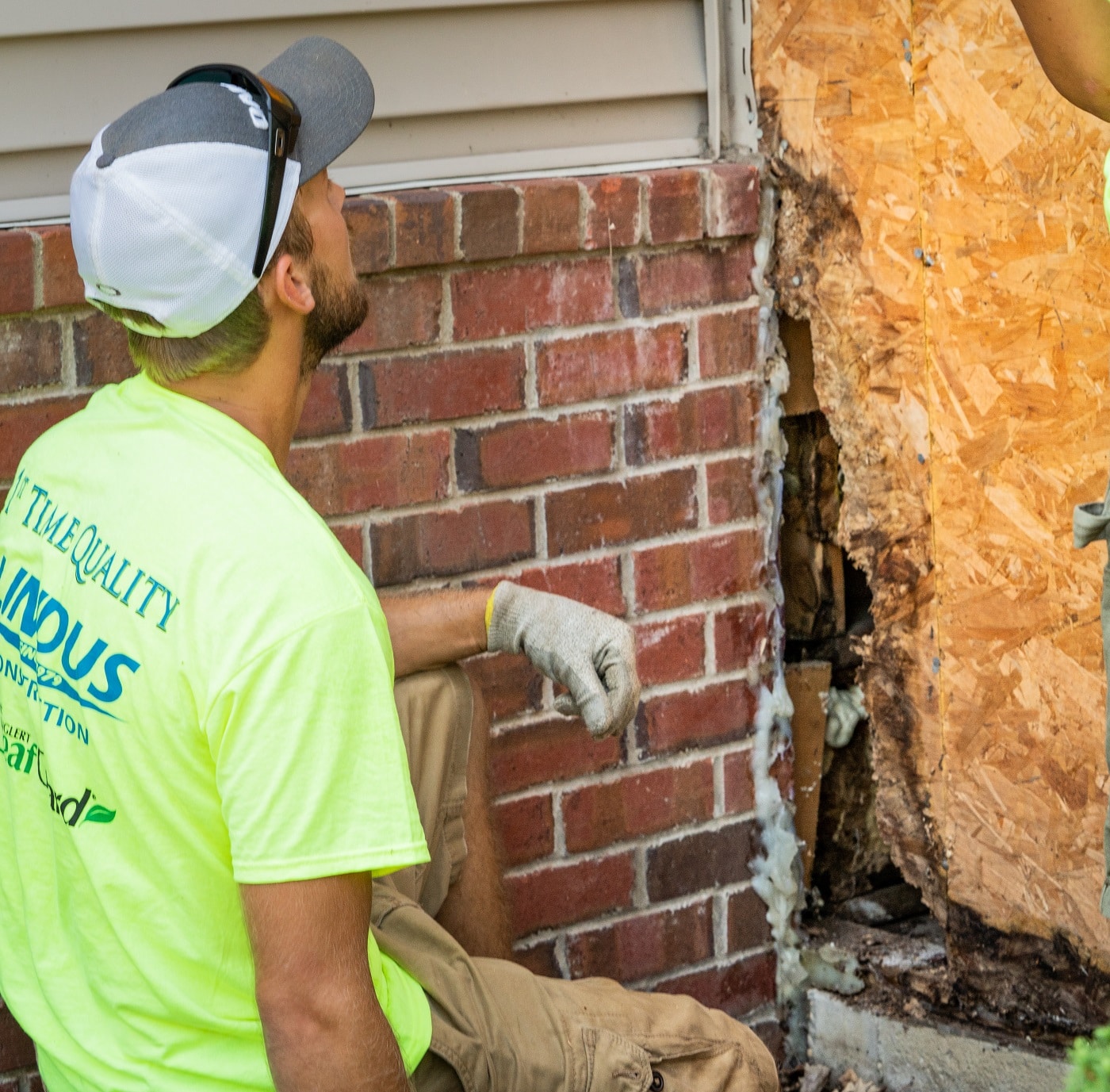  inspecting signs of dry rot on home by Lindus Construction