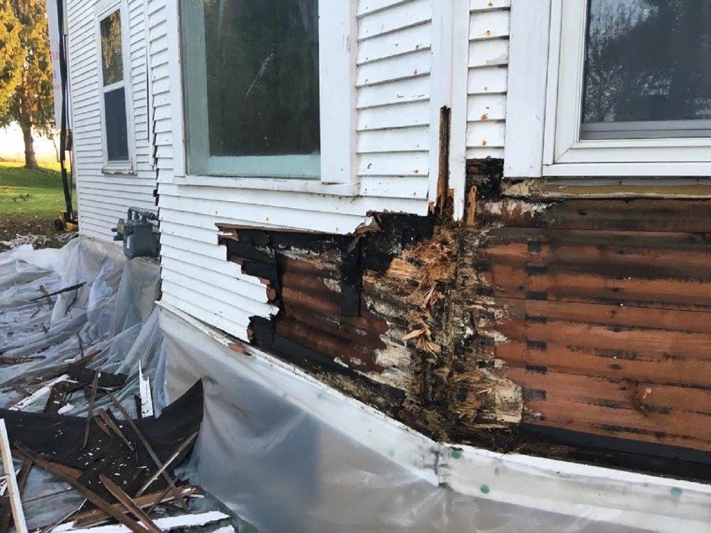 Damage to a home behind siding that has rotted