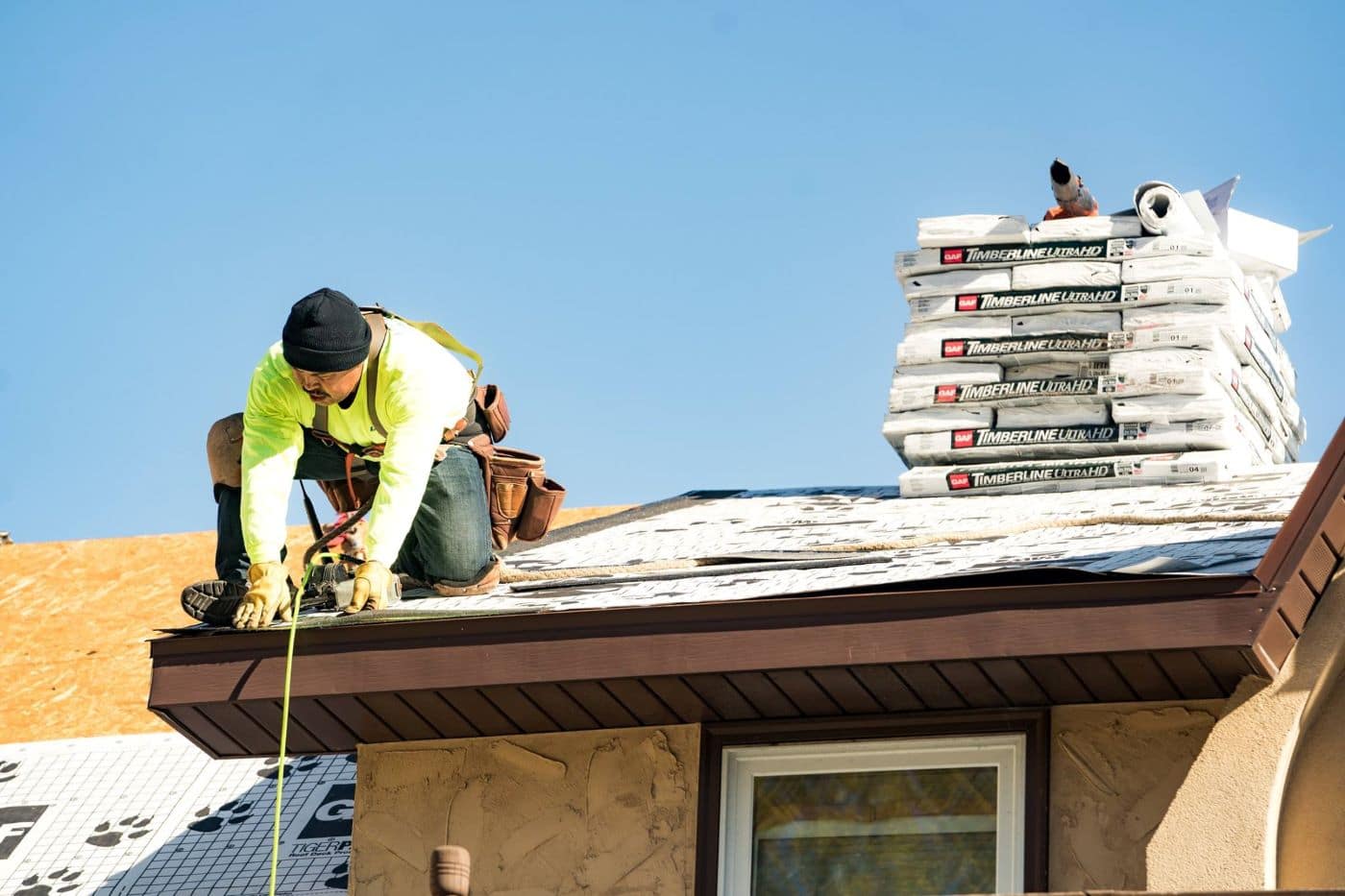 roofer installing GAF asphalt shingles
