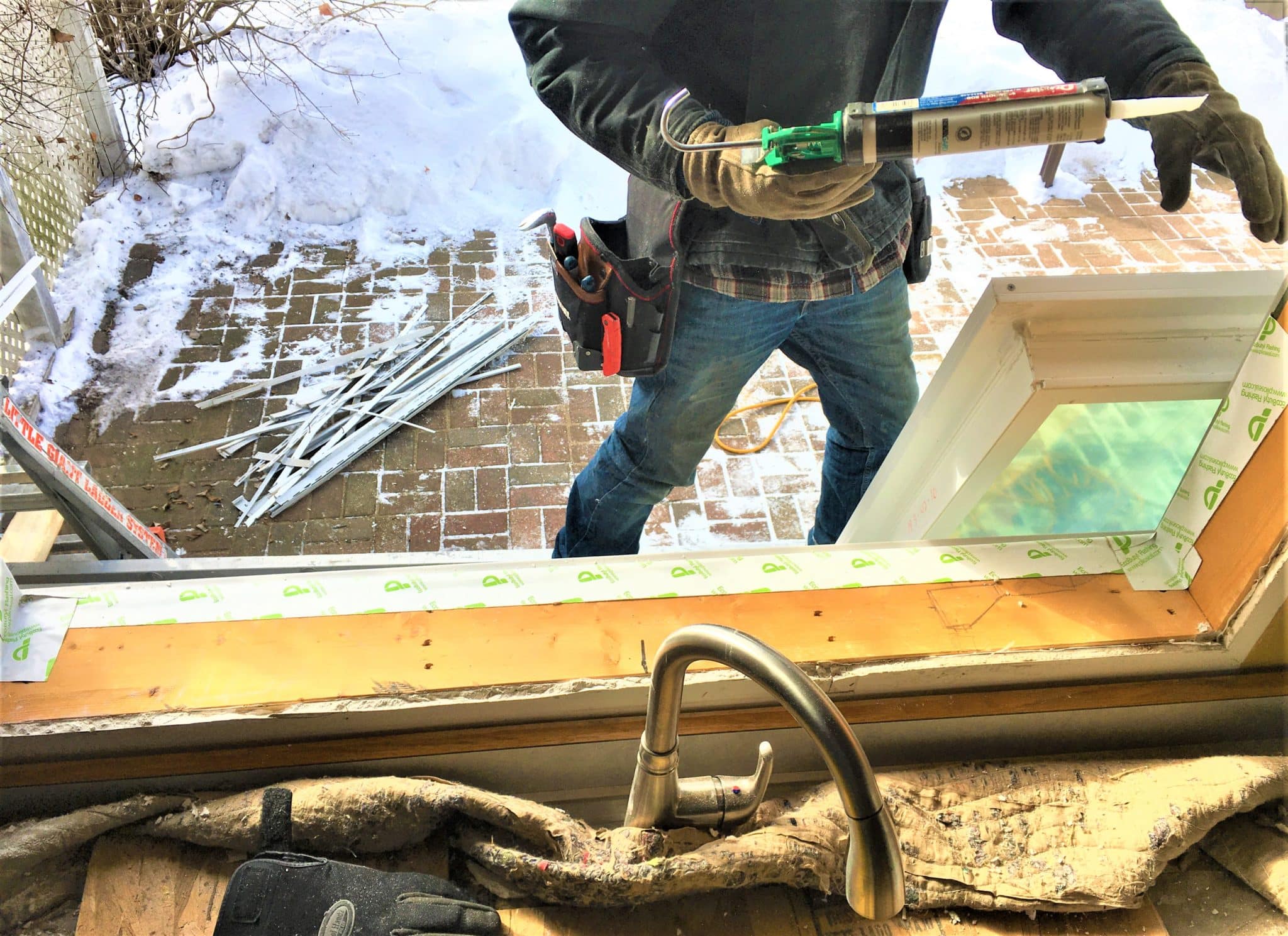 contractor installing replacement window in home