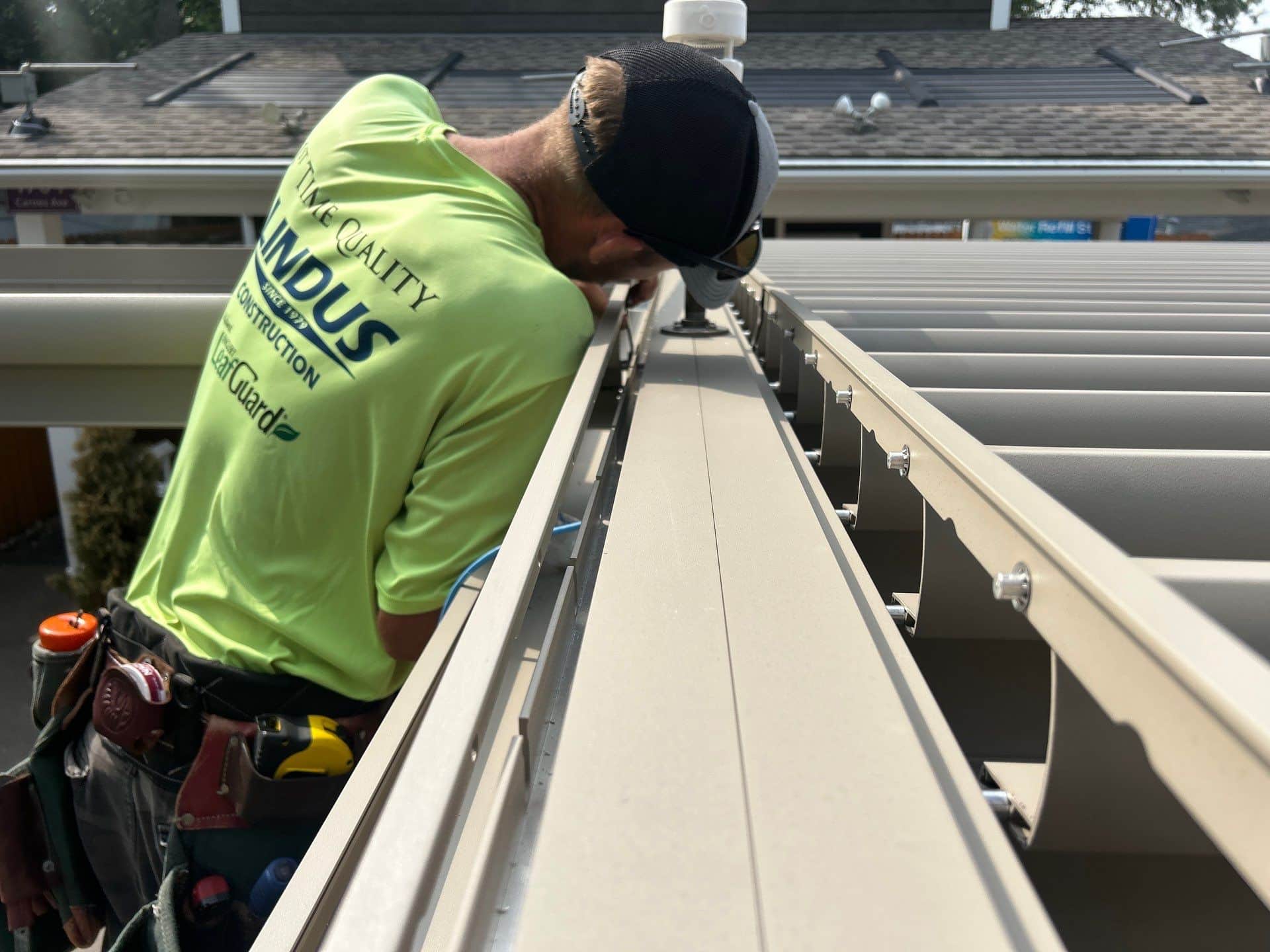 Lindus Construction craftsman installing the adjustable louvers on a StruXure Pergola X at the WCCO Radio booth at the Minnesota State Fair.